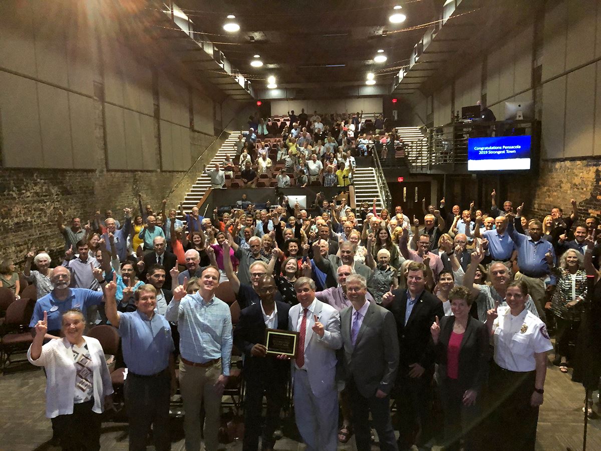 Crowd celebrates Pensacola's Strongest Town award at the Rex Theatre