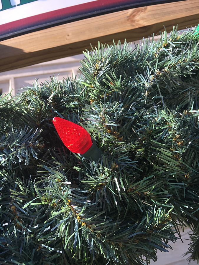 Red bulb on fire safety wreath