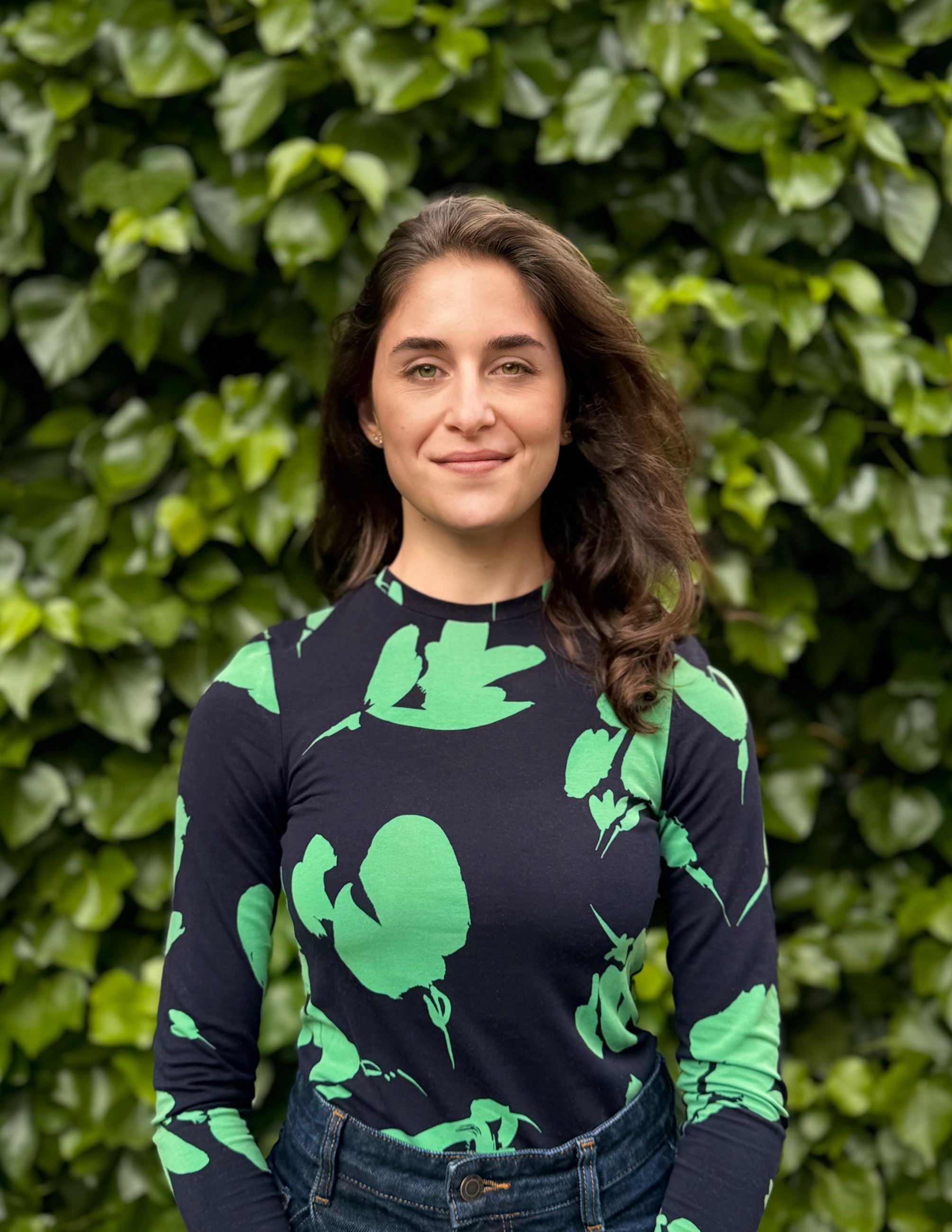 photo of woman standing in front of foliage